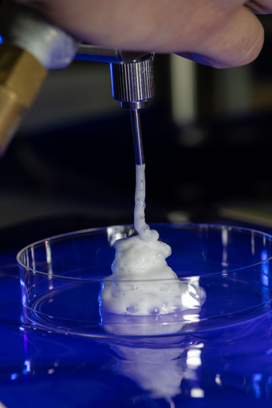 James Byrne, MD, PhD, in his lab at the University of Iowa’s Carver Biomedical Research Building on Thursday, Aug. 8, 2024. Byrne studies the use of molecular gastronomical techniques to create novel materials for the treatment for cancer, including the gas-entrapping foam pictured.