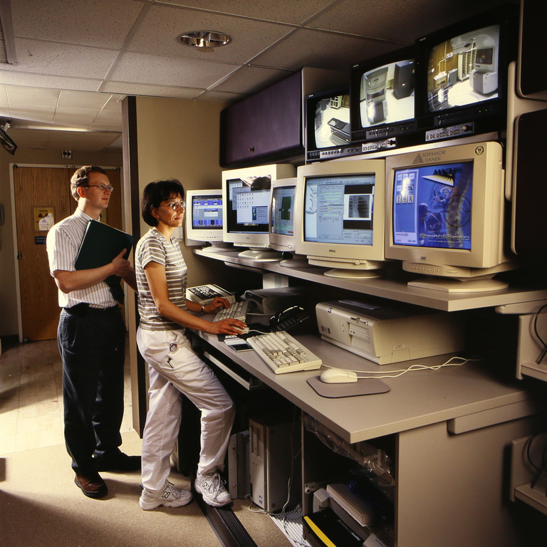 Ed Pennington (medical physicist), and Dolly Chesnut posed in front of Linac control terminals