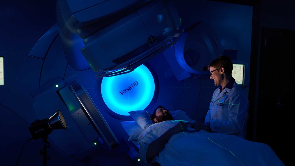 Dr Anderson next to a VERSA Linac with patient on couch
